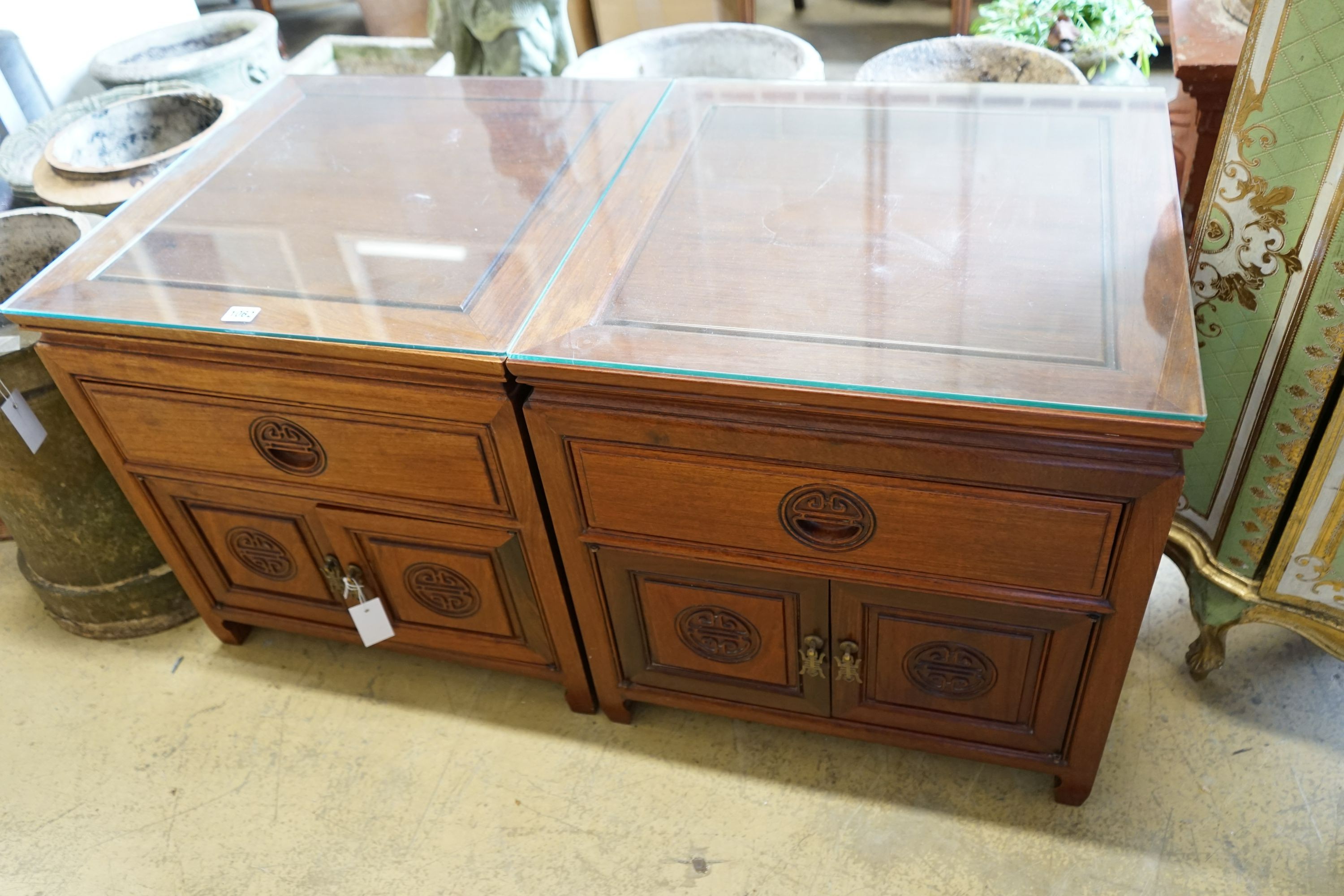 A pair of Chinese carved hardwood low cabinets, width 56cm, depth 56cm, height 56cm